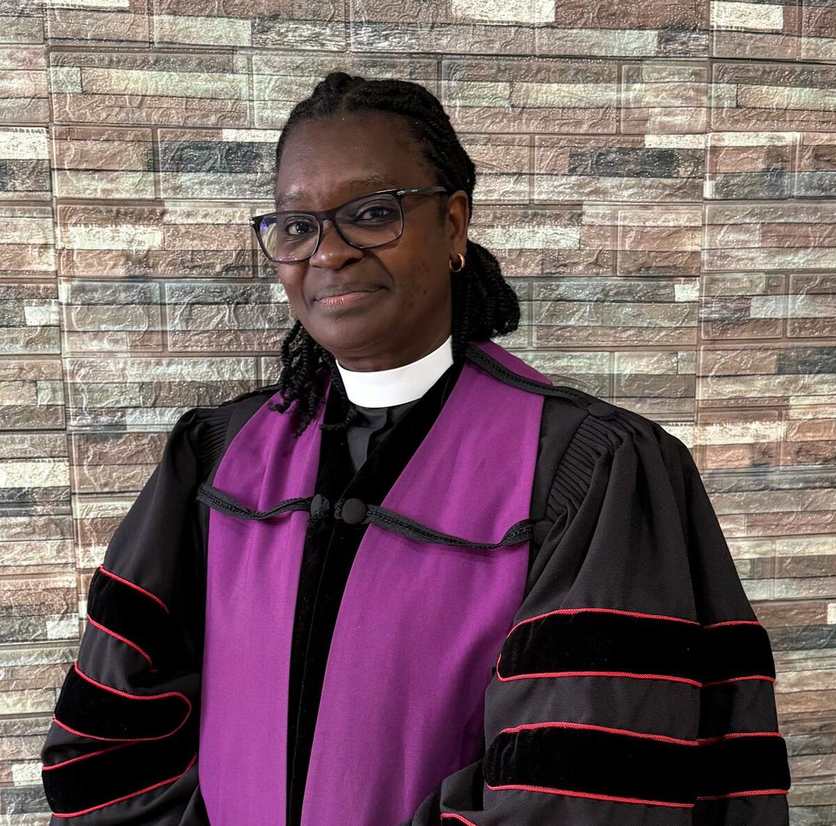 Rev. Dr. Josephine W. Mutuota in doctoral regalia